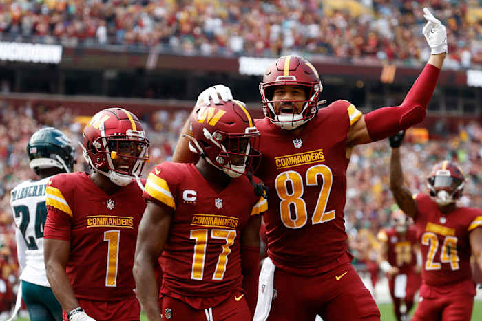 Washington Commanders wide receiver Terry McLaurin (17) celebrates with Commanders tight end Logan Thomas (82) after catching a touchdown pass against the Philadelphia Eagles during the first quarter at FedExField